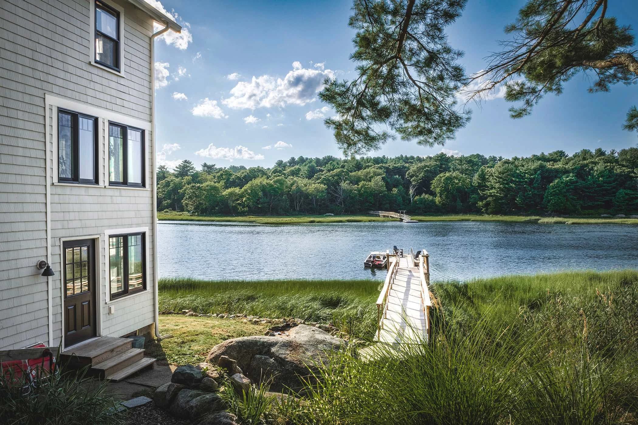 Waterfront home with private dock and pristine river views at Little River in Gloucester, Massachusetts